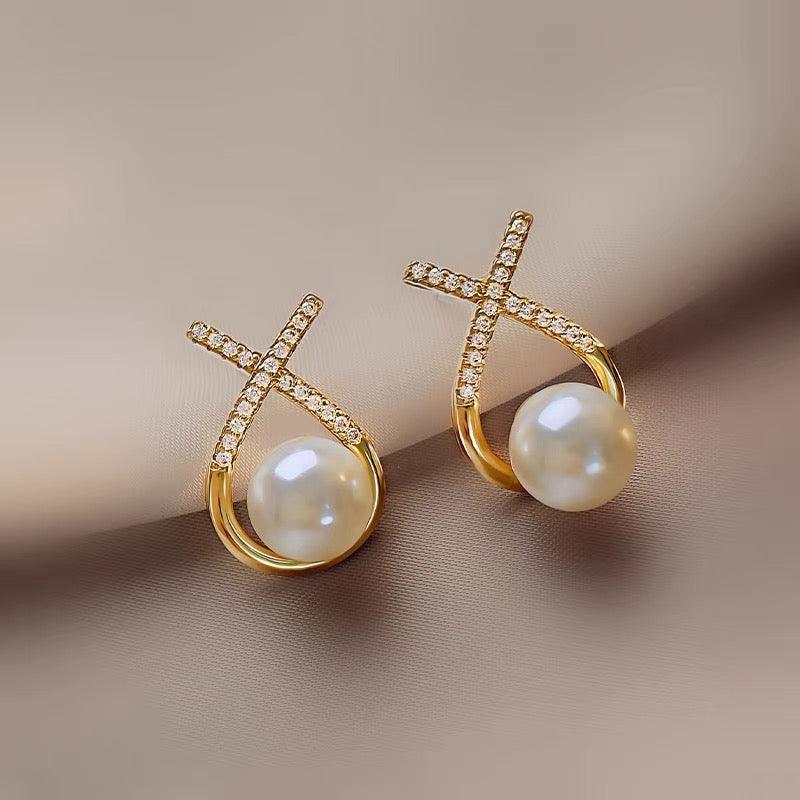 "Image: Exquisite pearl earrings showcased against a clean, white background. The pearls are lustrous, round, and elegantly set in a fine metal frame, creating a timeless and sophisticated accessory."