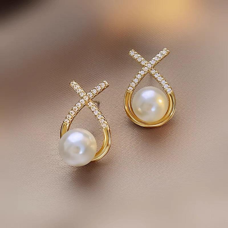 "Image: Exquisite pearl earrings showcased against a clean, white background. The pearls are lustrous, round, and elegantly set in a fine metal frame, creating a timeless and sophisticated accessory."